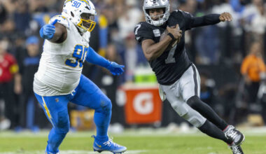Raiders quarterback Geno Smith (7) runs as he tries to escape pressure from Los Angeles Charger ...