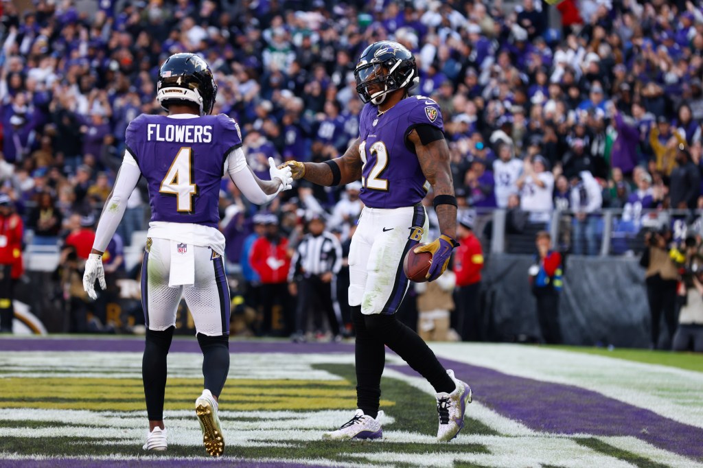 Baltimore Ravens running back Derrick Henry (22) and wide receiver Zay Flowers (4) celebrate a touchdown.