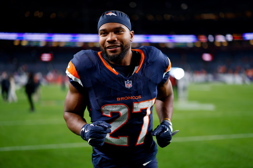 Denver Broncos player smiling on the field.