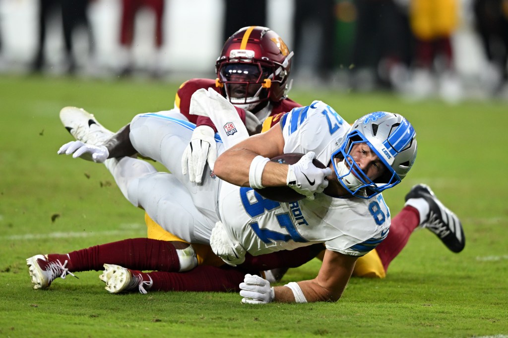 Sam LaPorta #87 of the Detroit Lions dives after a catch against the Washington Commanders in the first quarter of a game at Northwest Stadium on November 09, 2025 in Landover, Maryland.