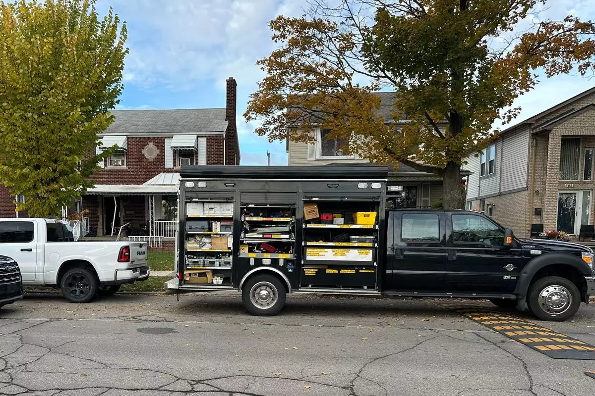 An FBI Evidence Response Team truck is seen idling in a Dearborn, Mich., neighborhood on Friday, Oct. 31, 2025. (AP Photo/Mike Householder)