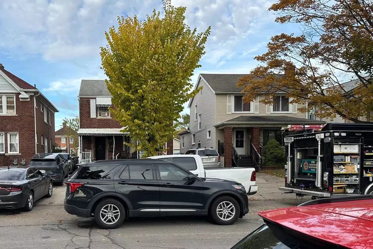 An FBI Evidence Response Team truck is seen idling in a Dearborn, Mich., neighborhood on Friday, Oct. 31, 2025. (AP Photo/Mike Householder)