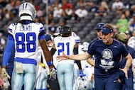 Dallas Cowboys head coach Brian Schottenheimer high fives Dallas Cowboys wide receiver...