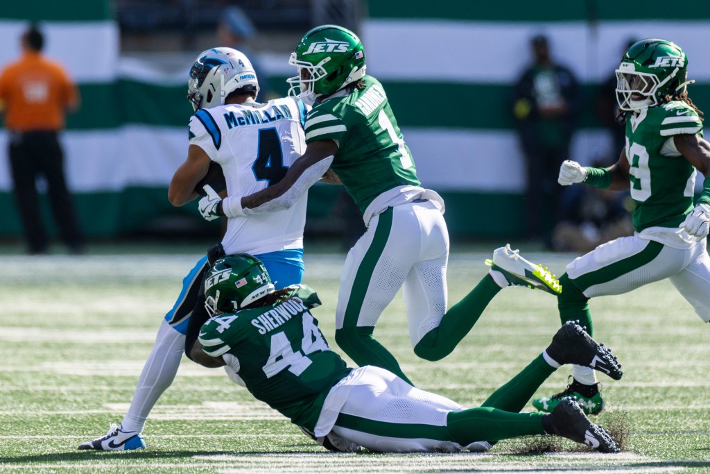 Jamien Sherwood #44 of the New York Jets makes a diving tackle as Sauce Gardner #1 of the New York Jets rushes Tetairoa McMillan #4 of the Carolina Panthers during the 2nd quarter at MetLife Stadium, Sunday, October 19, 2025, in East Rutherford, NJ. 