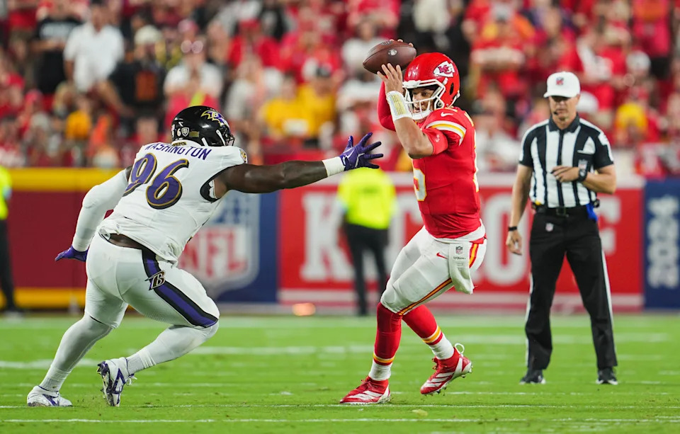 Sep 5, 2024; Kansas City, Missouri, USA; Kansas City Chiefs starting quarterback Patrick Mahomes (15) scrambles from Baltimore Ravens defensive tackle Broderick Washington (96) during the second half at GEHA Field at Arrowhead Stadium. Mandatory Credit: Jay Biggerstaff-Imagn Images