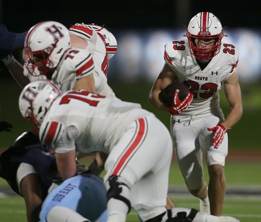 Rockwall Heath running back Carter Zahm (23), right, moves around his offensive line during...