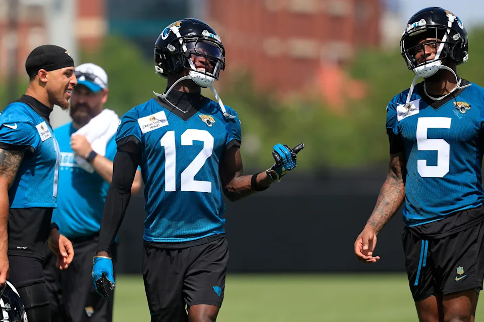 Jacksonville Jaguars wide receiver Travis Hunter (12) smiles with wide receiver Dyami Brown (5) during the 10th organized team activity at Miller Electric Center Wednesday, June 4, 2025 in Jacksonville, Fla. [Corey Perrine/Florida Times-Union]
