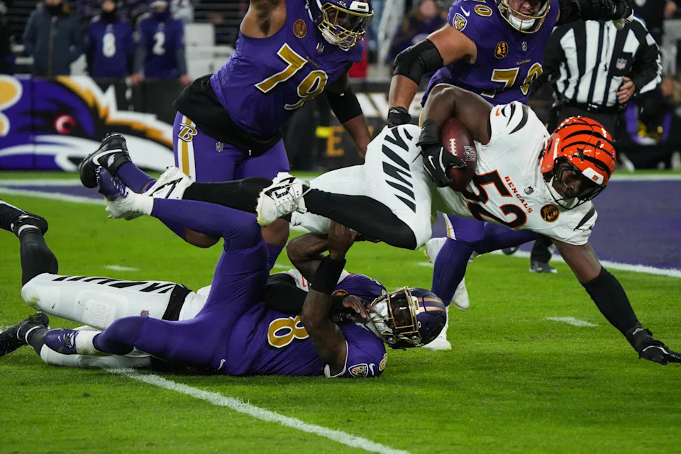 The Bengals' Cedric Johnson recovers a fumble against the Ravens