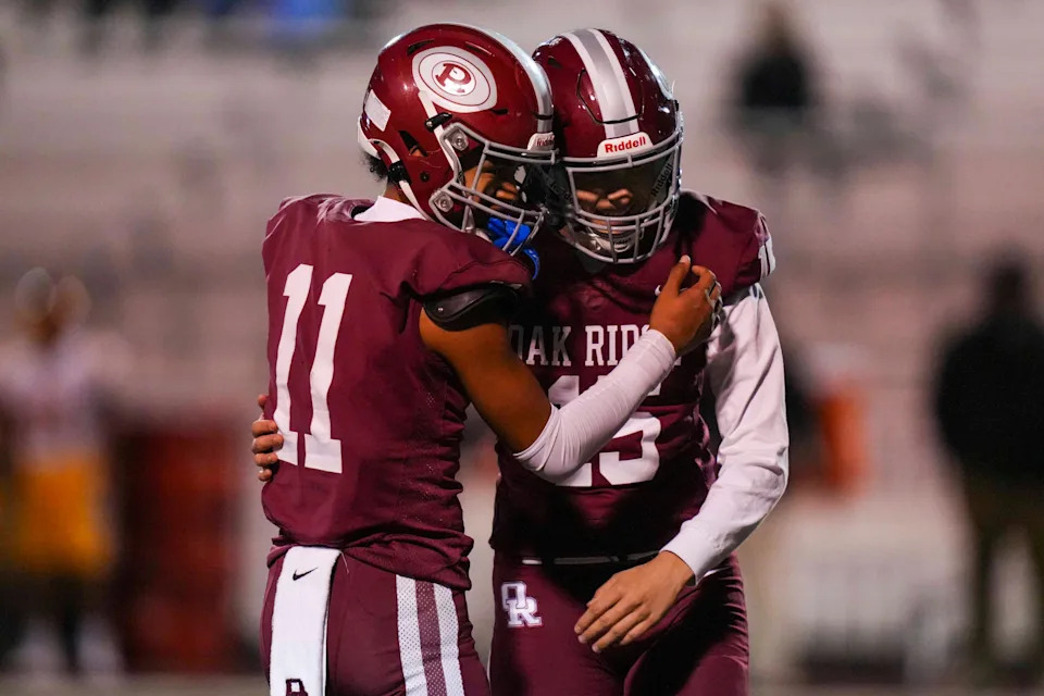 Oak Ridge's Adam Washington (11) and Oak Ridge's Eli Pearson (15) hug after Pearson makes a field goal before half-time during a TSSAA football play-off game between Oak Ridge and Science Hill in Oak Ridge, Tenn., on Nov. 6, 2025.