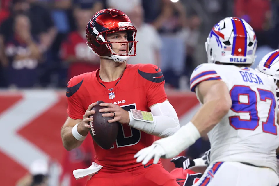 Nov 20, 2025; Houston, Texas, USA; Houston Texans quarterback Davis Mills (10) looks to pass against Buffalo Bills defensive end Joey Bosa (97) in the first quarter at NRG Stadium. Mandatory Credit: Troy Taormina-Imagn Images