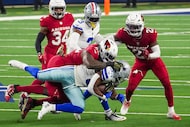 Dallas Cowboys running back Javonte Williams (33) is brought down by Arizona Cardinals...