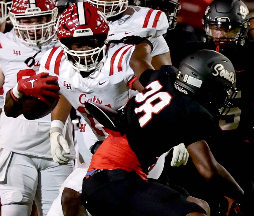 Lake Highlands running back Christian Rhodes (L) tries to get past South Grand Prairie...