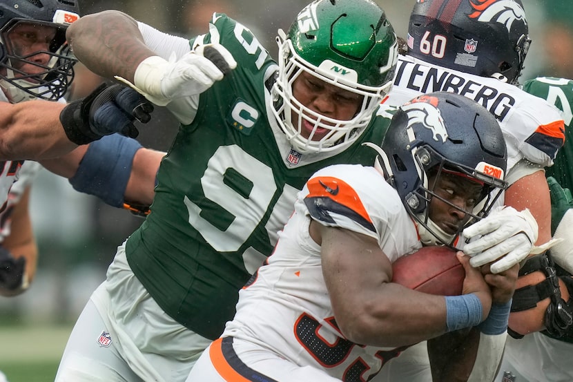 New York Jets defensive tackle Quinnen Williams (95) tackles Denver Broncos running back...