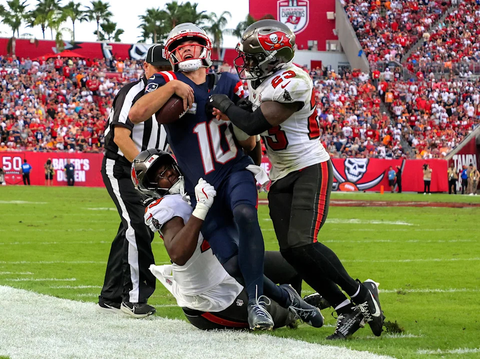Tampa, FL - November 9: New England Patriots quarterback Drake Maye is forced out of bounds by Tampa Bay Buccaneers linebacker Chris Braswell Jr. and safety Tykee Smith in the fourth quarter. The Patriots played the Buccaneers at Raymond James Stadium on November 9, 2025. (Photo by Matthew J. Lee/The Boston Globe via Getty Images)