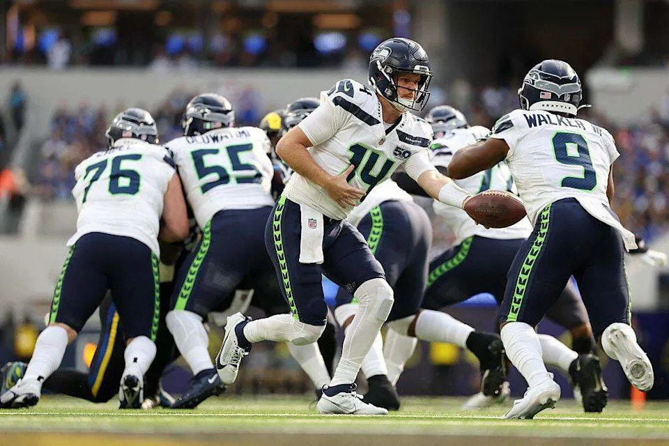 Seattle Seahawks quarterback Sam Darnold (14) hands the ball to teammate Kenneth Walker III (9) during the first quarter at SoFi Stadium on November 16, 2025 in Inglewood, California. (Photo by Sean M. Haffey/Getty Images) Sean M. Haffey/Getty Images