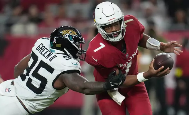 Jacksonville Jaguars defensive end BJ Green II (95) tackles Arizona Cardinals quarterback Jacoby Brissett (7) during the second half of an NFL football game Sunday, Nov. 23, 2025, in Glendale, Ariz. (AP Photo/Rick Scuteri)