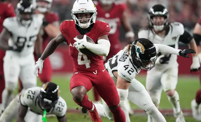 Arizona Cardinals wide receiver Greg Dortch (4) runs the ball during the second half of an NFL football game against the Jacksonville Jaguars Sunday, Nov. 23, 2025, in Glendale, Ariz. (AP Photo/Ross D. Franklin)