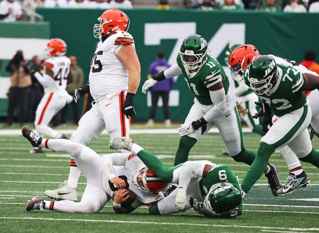 Will McDonald IV #9 of the New York Jets sacks Dillon Gabriel #8 of the Cleveland Browns.