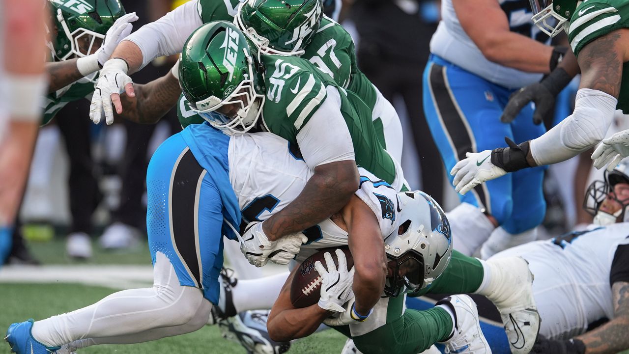 New York Jets defensive tackle Quinnen Williams (95) tackles Carolina Panthers running back Chuba Hubbard (30) during the fourth quarter of an NFL football game, Sunday, Oct. 19, 2025, in East Rutherford, N.J. (AP Photo/Seth Wenig)
