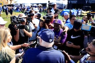 Dallas Cowboys owner Jerry Jones (back to camera) responds to questions from the media...