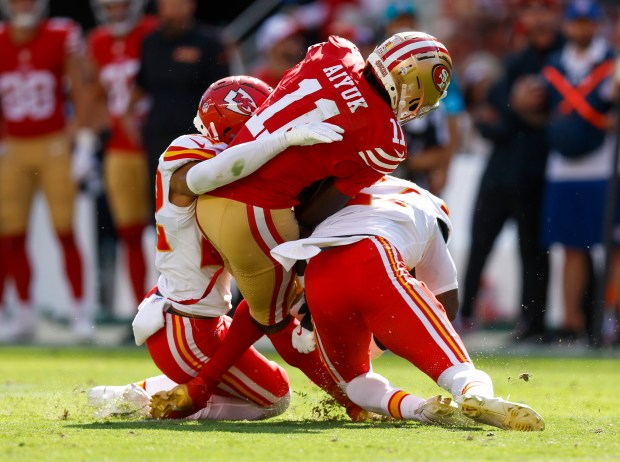 San Francisco 49ers' Brandon Aiyuk (11) is injured after making a catch against Kansas City Chiefs' Trent McDuffie (22) and Kansas City Chiefs' Chamarri Conner (27) in the second quarter at Levi's Stadium in Santa Clara, Calif., on Sunday, Oct. 20, 2024. (Nhat V. Meyer/Bay Area News Group)