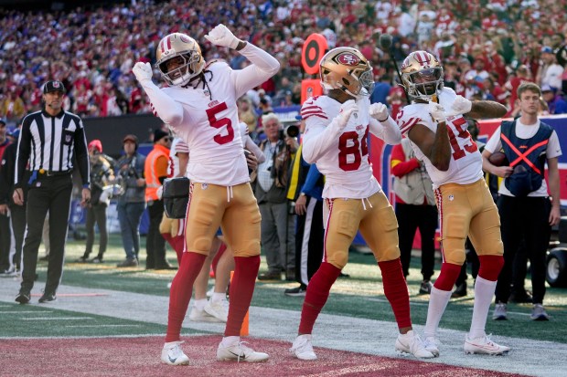 San Francisco 49ers wide receiver Jauan Jennings (15) celebrates with wide receiver Russell Gage (84) and wide receiver Demarcus Robinson (5) after scoring a touchdown against the New York Giants during the second quarter of an NFL football game, Sunday, Nov. 2, 2025, in East Rutherford, N.J. (AP Photo/Frank Franklin)