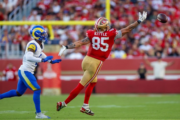 San Francisco 49ers' George Kittle (85) jumps for the ball against Los Angeles Rams' Kam Curl (3) during the fourth quarter at Levi's Stadium in Santa Clara, Calif., on Sunday, Nov. 9, 2025. (Shae Hammond/Bay Area News Group)