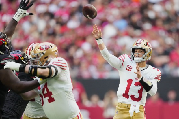 San Francisco 49ers quarterback Brock Purdy (13) passes against the Arizona Cardinals during the first half of an NFL football game in Glendale, Ariz., Sunday, Nov. 16, 2025. (AP Photo/Ross D. Franklin)