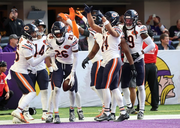 Chicago Bears cornerback Nahshon Wright (26) celebrates with his teammates after his interception in the second quarter of a game against the Minnesota Vikings at U.S. Bank Stadium in Minneapolis on Nov. 16, 2025. (Chris Sweda/Chicago Tribune)