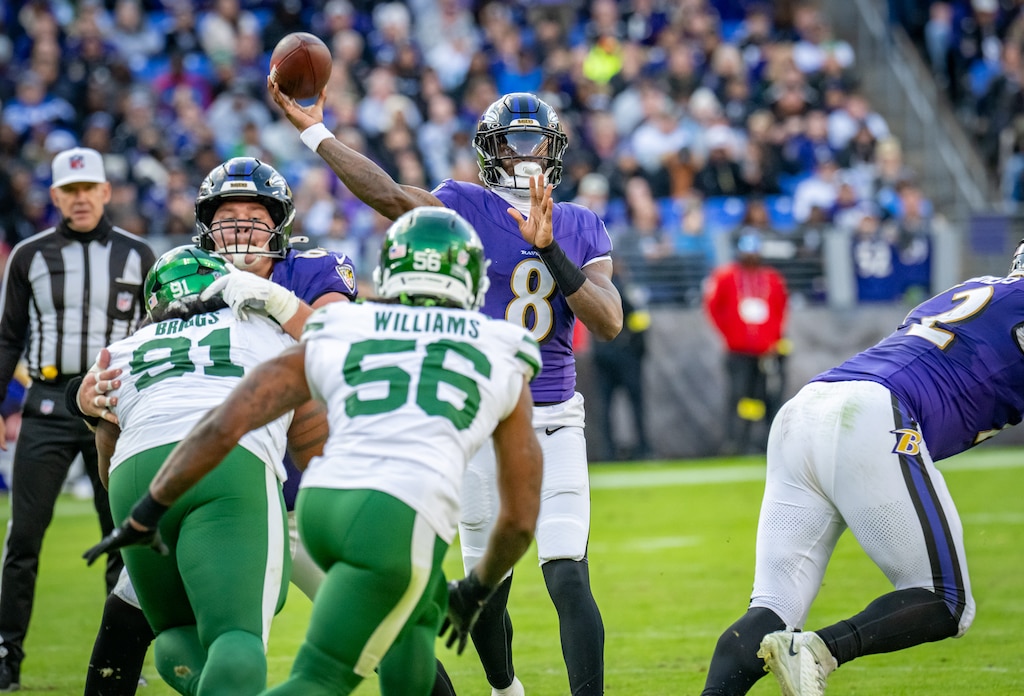 Sunday, Nov. 23, 2025 — Baltimore Ravens quarterback Lamar Jackson (8) looks for a target downfield in the 4th quarter against the New York Jets. The Ravens beat the Jets 23-10 at M&T Bank Stadium.