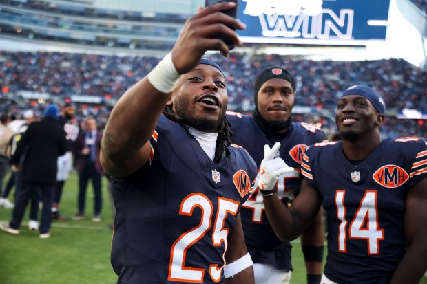 Bears running back Kyle Monangai (25), linebacker Amen Ogbongbemiga (45) and wide receiver Olamide Zaccheaus (14) celebrate after the defeating the Steelers 31-28 on Sunday, Nov. 23, 2025, at Soldier Field. (Eileen T. Meslar/Chicago Tribune)