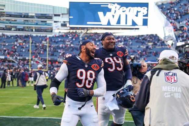 Bears defensive end Montez Sweat (98) and defensive tackle Gervon Dexter Sr. (99) celebrate after defeating the Steelers 31-28 on Sunday, Nov. 23, 2025, at Soldier Field. (Eileen T. Meslar/Chicago Tribune)