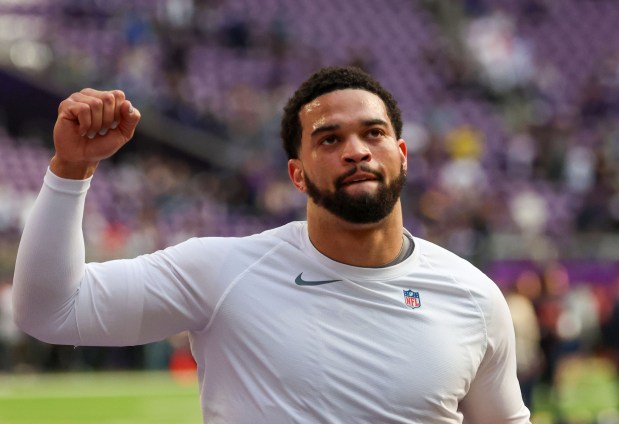 Bears quarterback Caleb Williams raises his fist while fans cheer him as he heads to the locker room after warmups before a game against the Vikings on Sunday, Nov. 16, 2025, at U.S. Bank Stadium in Minneapolis. (Stacey Wescott/Chicago Tribune)