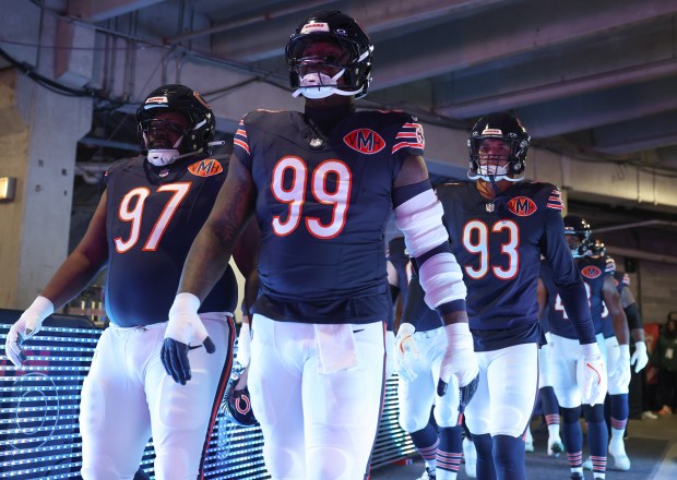 Bears defensive linemen Andrew Billings (97), Gervon Dexter Sr. (99) and Joe Tryon-Shoyinka (93) head to the field for a game against the Steelers on Sunday, Nov. 23, 2025, at Soldier Field. (John J. Kim/Chicago Tribune)