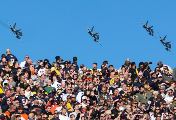 A quartet of fighter jets fly over Soldier Field after the national anthem before a Bears-Steelers game Sunday, Nov. 23, 2025, at Soldier Field. (John J. Kim/Chicago Tribune)