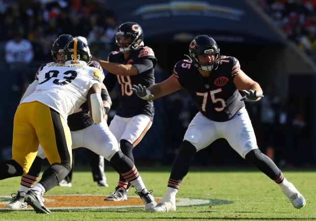 Bears offensive tackle Ozzy Trapilo (75) works to protect quarterback Caleb Williams in the second quarter against the Steelers on Sunday, Nov. 23, 2025, at Soldier Field. (John J. Kim/Chicago Tribune)