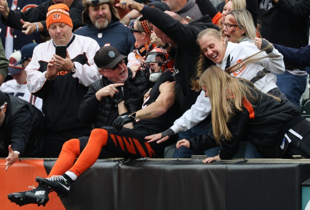 Bengals wide receiver Charlie Jones celebrates with fans after a...