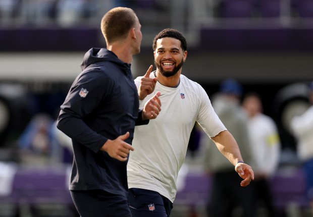 Bears quarterbacks Caleb Williams, right, and Tyson Bagent have a laugh as they warm up for a game against the Vikings on Sunday, Nov. 16, 2025, at U.S. Bank Stadium in Minneapolis. (Chris Sweda/Chicago Tribune)