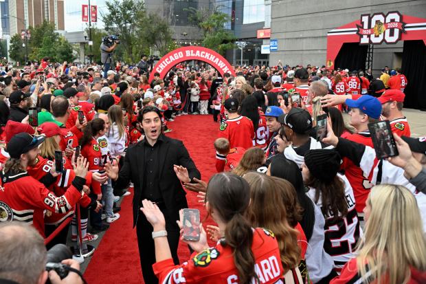 Chicago Blackhawks center Frank Nazar greets fans on a red carpet before an NHL hockey game against the Montreal Canadiens, Saturday, Oct. 11, 2025, in Chicago. (AP Photo/Matt Marton)