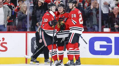 Nov 18, 2025; Chicago, Illinois, USA; Chicago Blackhawks center Connor Bedard (98) celebrates with teammates after scoring against the Calgary Flames during the second period at United Center.