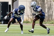Dallas Cowboys cornerbacks Kaiir Elam (right) and Robert Rochell (30) participate in a drill...