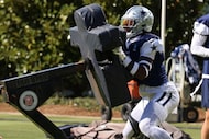Dallas Cowboys linebacker DeMarvion Overshown (0) tackles a football dummy during Cowboys...