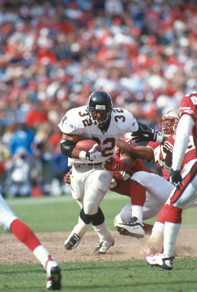 Jamal Anderson #32 of the Atlanta Falcons runs the ball against the San Francisco 49ers during an NFL football game on September 29, 1996 at Candlestick Park in San Francisco, California.  Anderson played for the Falcons from 1994-2001. 