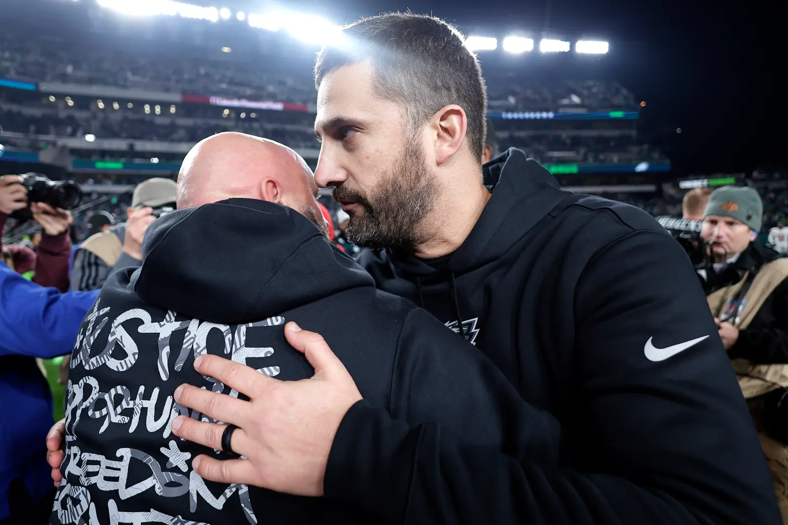 Head coach Nick Sirianni of the Philadelphia Eagles hugs head coach Brian Daboll of the New York Giants