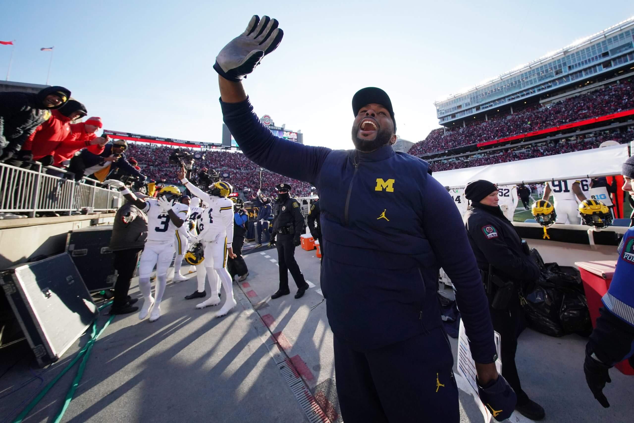 Michigan coach Sherrone Moore waves to the crowd leaving Ohio Stadium last year