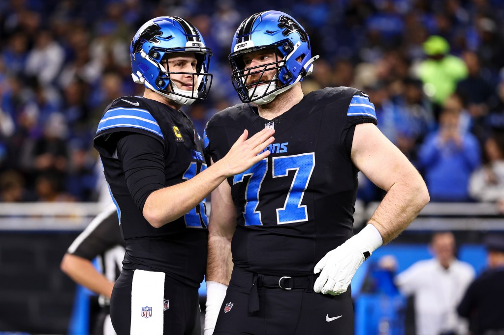 Jared Goff #16 of the Detroit Lions talks with Frank Ragnow #77 prior to an NFL football game against the Minnesota Vikings.
