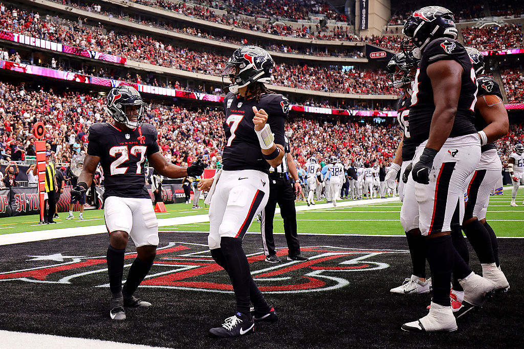 HOUSTON, TEXAS - SEPTEMBER 28: Woody Marks #27 of the Houston Texans celebrates a touchdown against the Tennessee Titans with teammate C.J. Stroud #7 of the Houston Texans during the fourth quarter in the game at NRG Stadium on September 28, 2025 in Houston, Texas. (Photo by Alex Slitz/Getty Images)