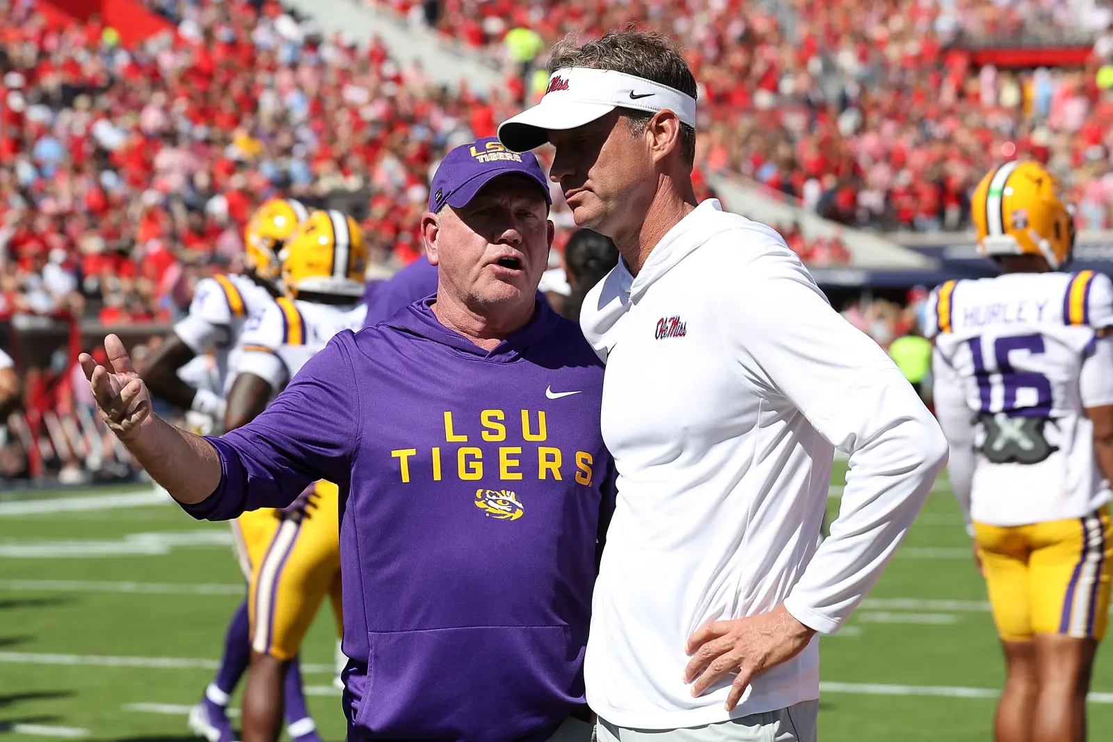 Head coach Brian Kelly of the LSU Tigers and Head coach Lane Kiffin of the Mississippi Rebels