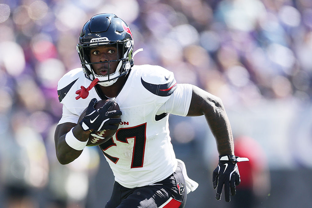 BALTIMORE, MARYLAND - OCTOBER 05: Woody Marks #27 of the Houston Texans carries the ball during the second quarter against the Baltimore Ravens in the game at M&T Bank Stadium on October 05, 2025 in Baltimore, Maryland. (Photo by Patrick Smith/Getty Images)