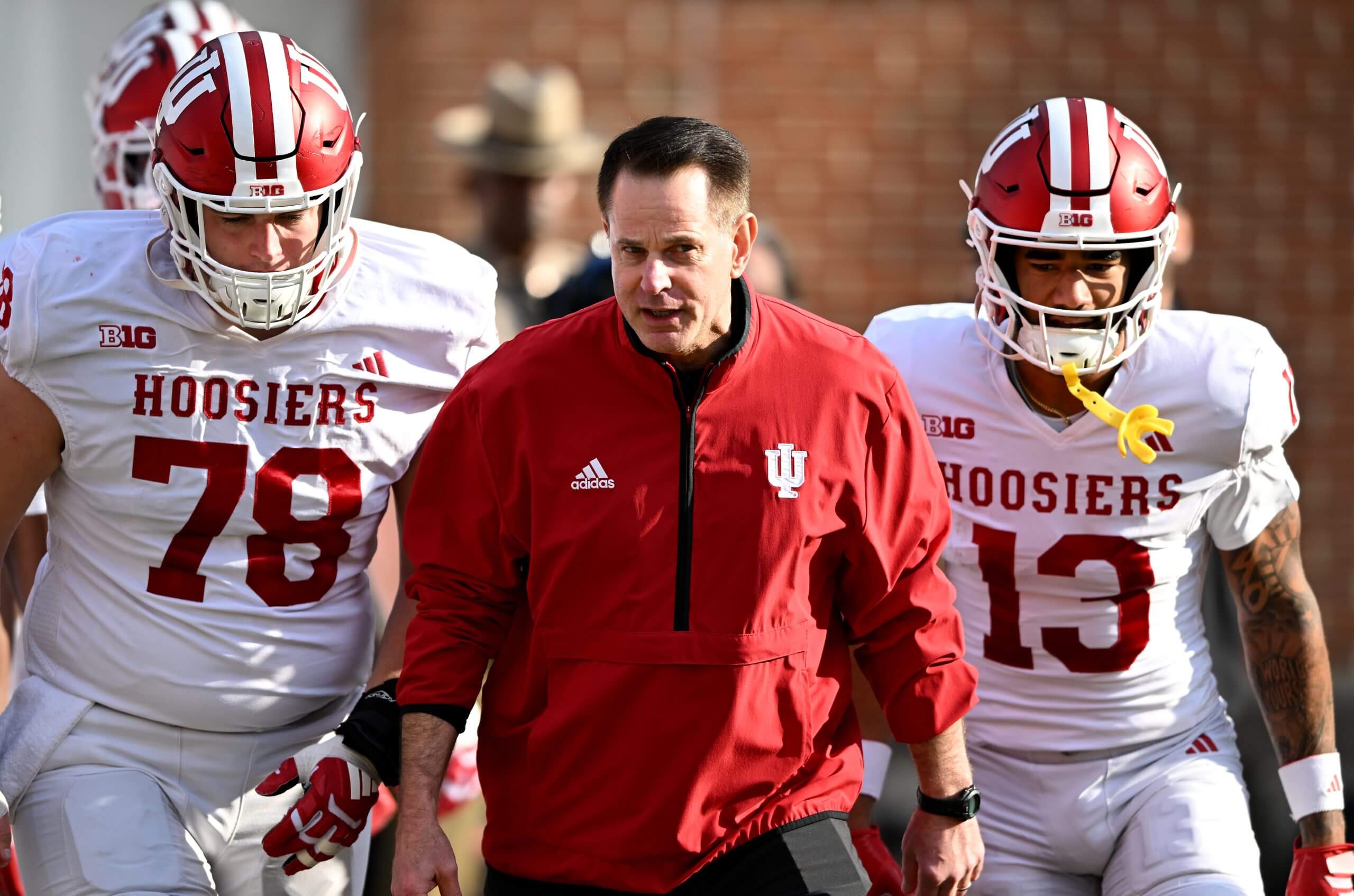 Indian coach Curt Cignetti leads Hoosiers football players onto the field before last week's game at Maryland.